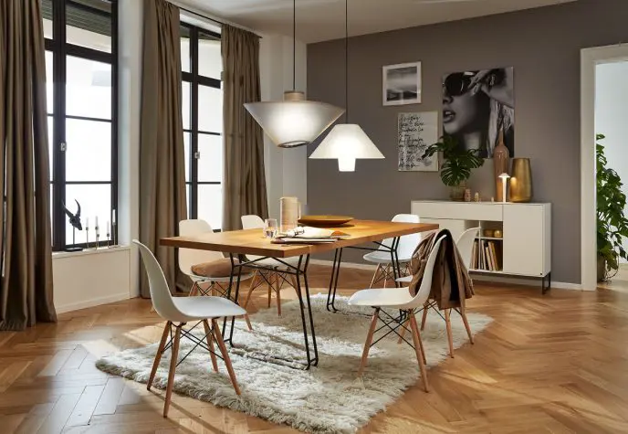 Living room of a house with designer chandeliers. The floor is a parquet and the living room is in the tones of the turtledove