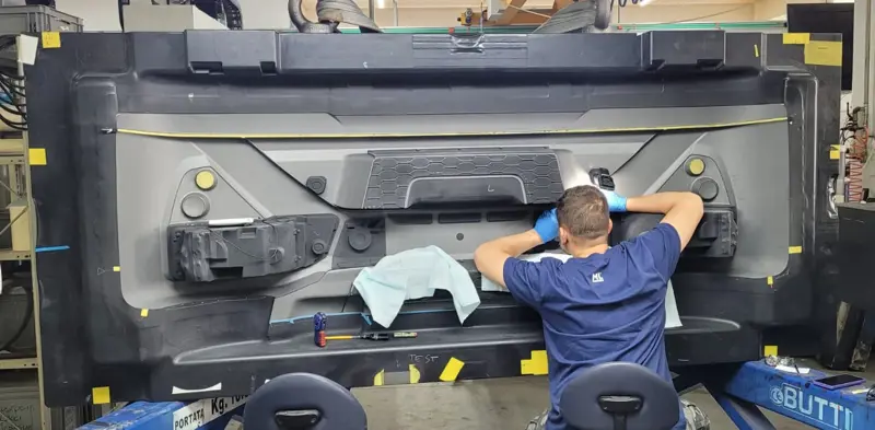 Workers who are working on a large mold